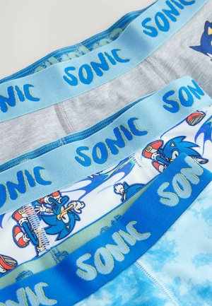 Kolme paria poikien alusvaatteita, joissa on siniset ja harmaat elastiset vyöt, joissa lukee "SONIC". Alusvaatteilla on värikkäitä sarjakuvakuvastoja Sonic the Hedgehogista.