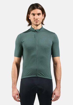 Short-sleeve cycling jersey in dark green fabric with a half zipper and a high collar, featuring a fitted design and logo detail on the front.
