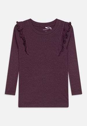 Długie rękawy fioletowej koszulki prążkowanej z okrągłym dekoltem i falbankami na przednich ramionach, rozmiar dla dziecka 2-3 lata.