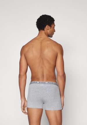 Graue Boxershorts mit einem nahtlos passenden, im Navy gehaltenen Bündchen. Der Stoff wirkt weich und elastisch. Die Passform ist eng und tailliert.