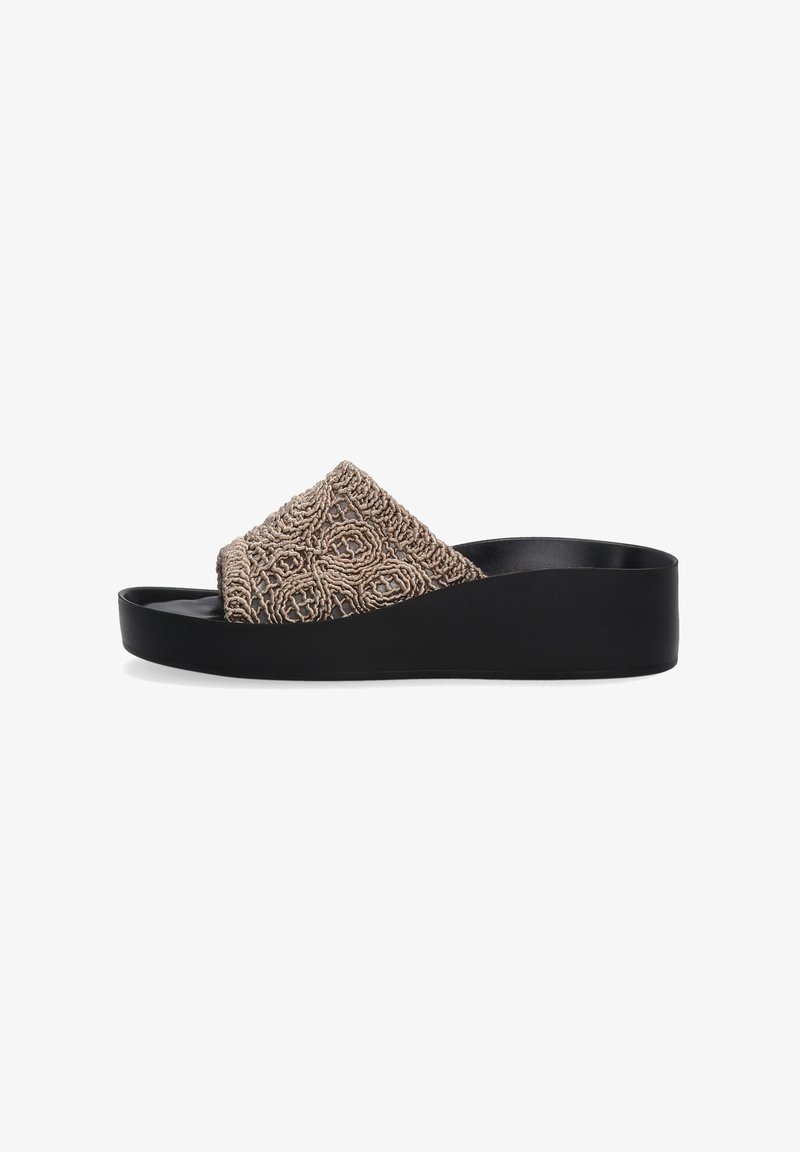 Platform slide sandal with a textured beige upper featuring intricate patterns, contrasted by a sleek black rubber sole.