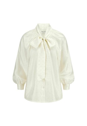 Witte blouse van gladde stof met pofmouwen, een strikboord, en kleine decoratieve stippen over de gehele blouse. Voorzijde met knoopsluiting.