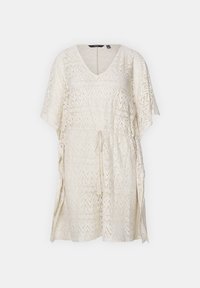 Tunika in pizzo color crema con scollatura a V e maniche ampie, caratterizzata da un motivo a zig zag e vita arricciata per una vestibilità regolabile.