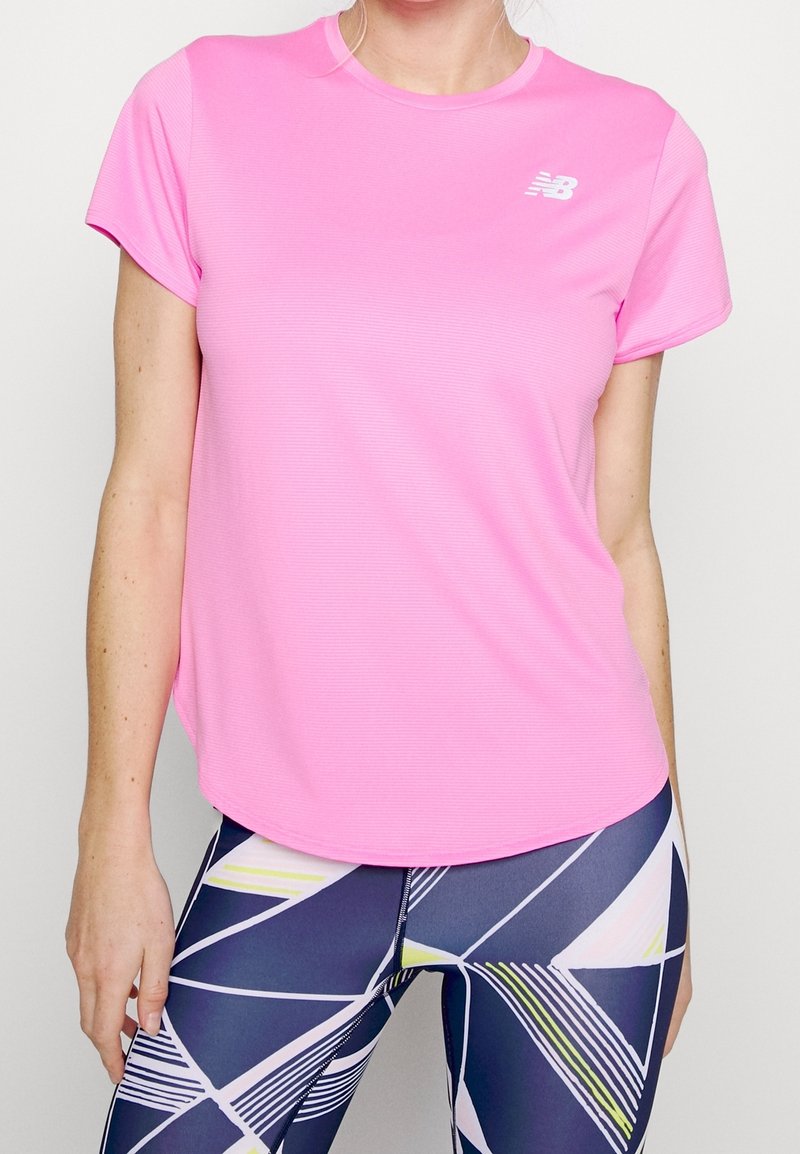 Bright pink short-sleeve athletic shirt with a round neck and subtle texture. Features logo on the chest and casual fit.