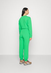 Modström HOLLY PANTS - Calças de fato de treino - island green