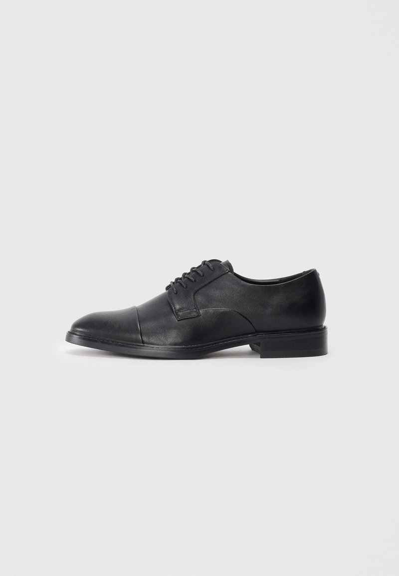 Black leather dress shoe with a smooth finish, rounded toe, and lace-up design; features stitching detail on the upper and a flat sole.
