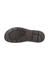 Suela de zapato de goma negra con profundos surcos y un patrón ondulado. Presenta una superficie lisa y plana con bordes reforzados para mayor durabilidad.