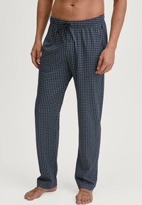 Pantaloni lounge blu navy con un motivo geometrico, vita elasticizzata con cordino e vestibilità ampia. Realizzati in morbido tessuto, adatti per un indossare confortevole.