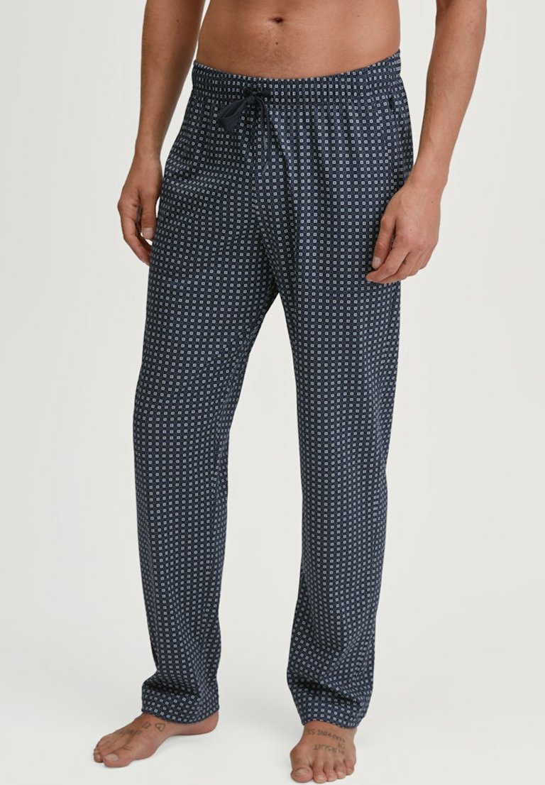 Pantaloni lounge blu navy con un motivo geometrico, vita elasticizzata con cordino e vestibilità ampia. Realizzati in morbido tessuto, adatti per un indossare confortevole.