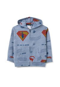 Felpa blu con zip caratterizzata da grafiche a tema Superman, inclusi loghi e testo, con una texture morbida e tasche a marsupio.