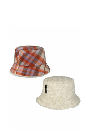 Two bucket hats, one orange and purple plaid wool, the other cream-colored fluffy with a small black label.