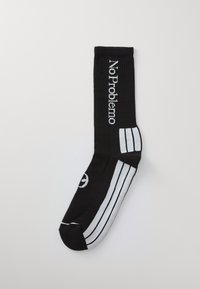 Black sock with ribbed texture featuring white text "No Problemo" and three white stripes on the side. Rounded toe and solid heel.