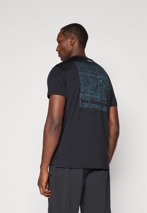 Black short-sleeve t-shirt featuring a toroidal pattern in teal on the back, made of lightweight material; relaxed fit with subtle side slits.
