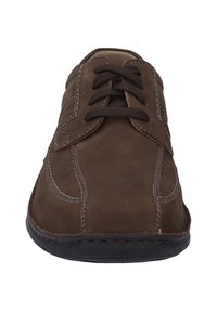 Brown leather shoe with a rounded toe, contrasting white stitching, and brown laces. The sole is black with a textured finish.