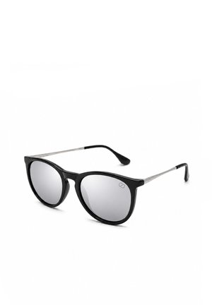 Lunettes de soleil noires avec verres ronds miroités et branches métalliques fines, présentées en angle sur fond blanc.