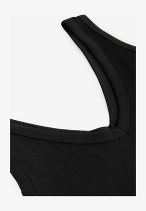 Top senza maniche nero con scollatura ampia e cuciture piatte, realizzato in tessuto morbido. La texture appare liscia e opaca.