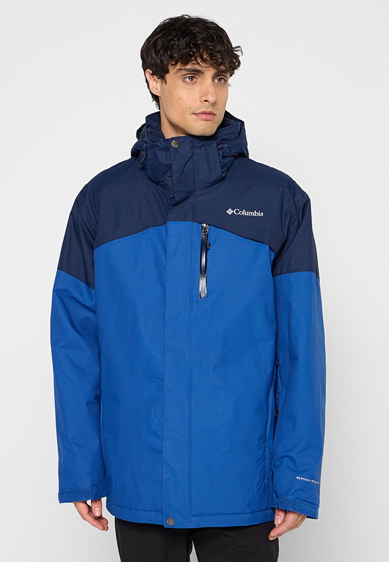 Blauwe waterdichte jas met een marineblauwe bovenste sectie, verstelbare capuchon, ritszak aan de voorkant en elastische manchetten voor een veilige passing.