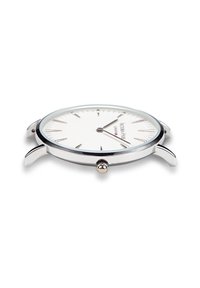 Reloj de pulsera de metal plateado con una esfera blanca, marcadores de horas delgados y una corona prominente en el lado derecho. Presenta un diseño minimalista.