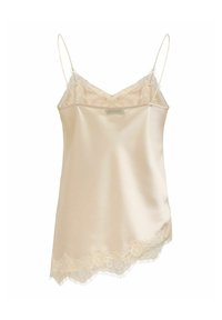 Caraco en satin crème avec fines bretelles spaghetti et bordure en dentelle le long du décolleté en V et de l'ourlet asymétrique.
