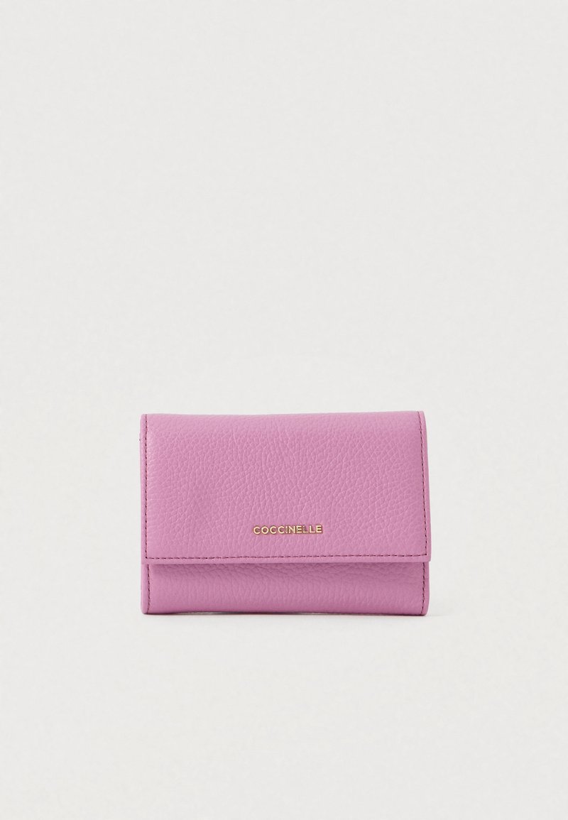 Compact pink textured leather wallet with gold "COCCINELLE" logo centered on front flap against plain background.