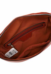 Brown leather handbag interior with a zip pocket and a textured accent. Features a smooth inner lining and contrasting stitching details.