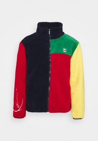 Fleece bunda se zipem, v modré, červené, zelené a žluté barvě. Texturovaná látka s nášivkou loga a bílým vzorem na rukávu.