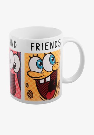 Mug in ceramica bianca con immagini cartoon di personaggi con grandi occhi e sorrisi, su sfondi colorati con pois.