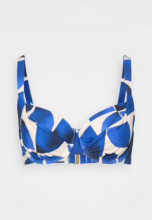 Modra in smetanasta nedrček z vzorcem, s podlogo, nastavljivimi naramnicami in zlatim sponko. Ima drzne geometrijske oblike in gladko teksturo.