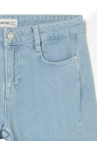 Light blue denim shorts with a straight cut, featuring a front pocket, button closure, and visible stitching details.