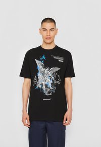 Schwarzes Baumwoll-T-Shirt mit grafischem Design einer himmlischen Figur und Text. Kurze Ärmel, runder Ausschnitt und lockere Passform.