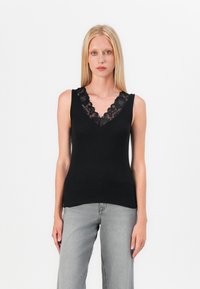 Black sleeveless top with a deep V-neck featuring floral lace trim. Smooth, lightweight fabric; fitted silhouette enhances the body's shape.