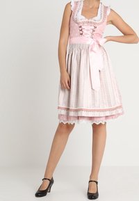 Pink dirndl dress with white polka dots, lace trim, and a satin belt. Features a fitted bodice and flared skirt with patterned detailing.