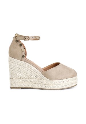 Scarpa wedge in suede beige con cinturino alla caviglia, caratterizzata da dettagli in metallo dorato e una piattaforma in corda intrecciata. Punta arrotondata e superficie testurizzata.