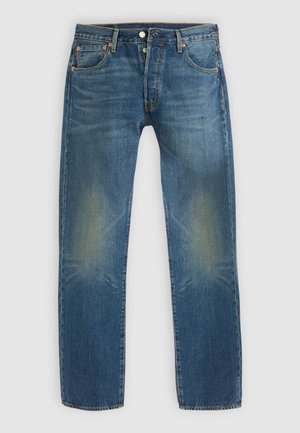 Jean bleu en denim avec une coupe droite. Zones décolorées sur les cuisses et détails de couture subtils. Fermeture à bouton en métal et à glissière.