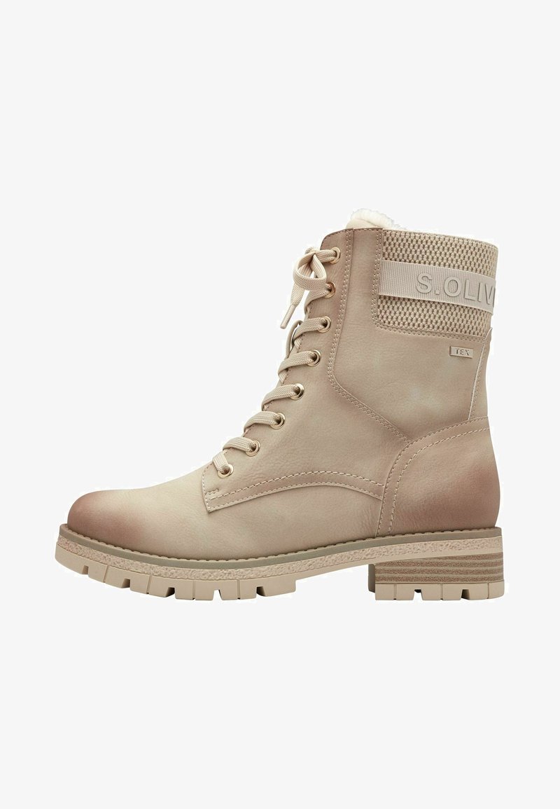 Beige ankle boot made of smooth leather, featuring a padded collar, lace-up front, and textured rubber sole with deep treads.