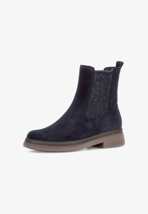 Dark blue suede ankle boot with a textured woolen side panel and a light brown rubber sole; features a back pull tab for easy wear.