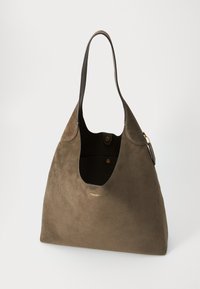 Brown suede tote bag with a wide opening, curved shape, and a long handle. Features a gold logo and interior pocket with button closure.