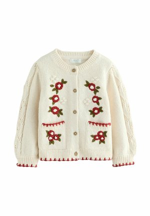 Cream knitted cardigan featuring floral embroidery in red and green, wooden buttons, cable-knit sleeves, and decorative red trim.