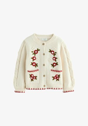 Cream knitted cardigan featuring floral embroidery in red and green, wooden buttons, cable-knit sleeves, and decorative red trim.