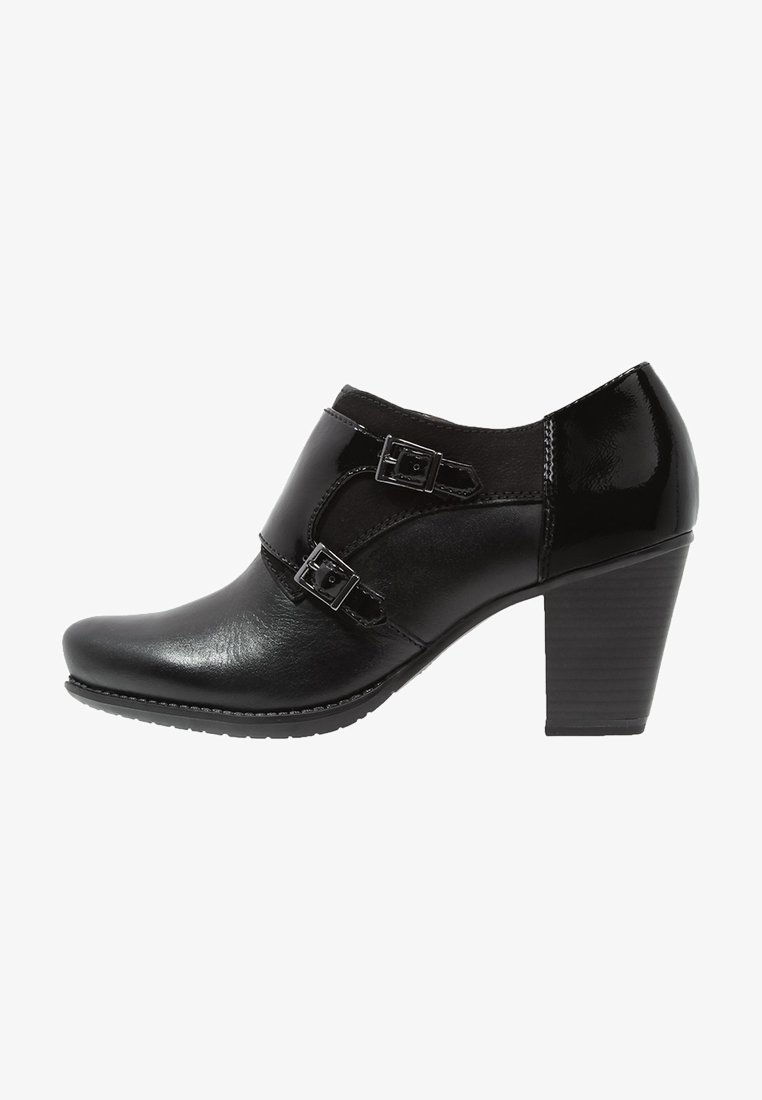 Bottine pour femme en cuir noir avec deux boucles latérales et un talon bloc empilé.