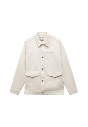 Vaaleanbeige takki, jossa on kauluspääntie, napitus edessä, kaksi rintataskua ja pitkät hihat, valmistettu tekstuurisesta kankaasta.