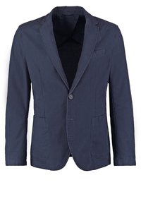 Mörkblå bomullsblazer med slagkrage, enknapsstängning, två framfickor och en bröstficka. Slät yta, strukturerad form.