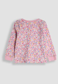 Vaaleanpunainen pitkähihainen paita, jossa on kukka- ja yksisarvisprintti. Pehmeä kangas, jossa on ribbikuvioiset vaaleanpunaiset hihansuut ja kaulus.