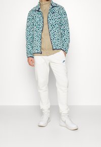 Nike Sportswear Tracksuit bottoms - off-white