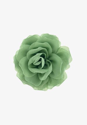 Fiore di tessuto verde con petali stratificati e traslucidi che ricordano una rosa, mostrato su uno sfondo bianco.