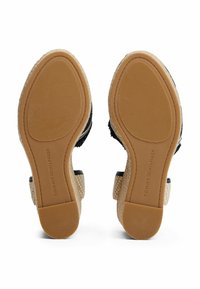 Espadrille sandals with a woven fabric upper in black, rubber sole, and jute accents. Features textured grip for traction and brand logo.