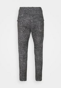 Grijze gepatterneerde broek van een textiel met structuur, slank model, en twee achterzakken, met een hoge taille en taps toelopende pijpen.