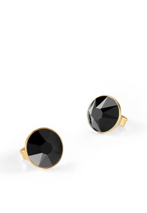 Boucles d'oreilles cloutées noires en métal doré, présentant des formes rondes aux bords lisses. Les surfaces réfléchissantes accentuent le design.