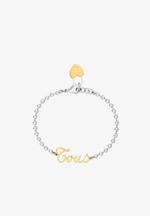 Armband mit Silberperlenkette, goldener "Tous"-Schrift und einem kleinen goldenen herzförmigen Anhänger nahe dem Verschluss.