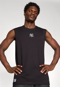 Black sleeveless shirt with a round neck, featuring a white embroidered New York Yankees logo on the chest and a small MLB logo on the side seam.